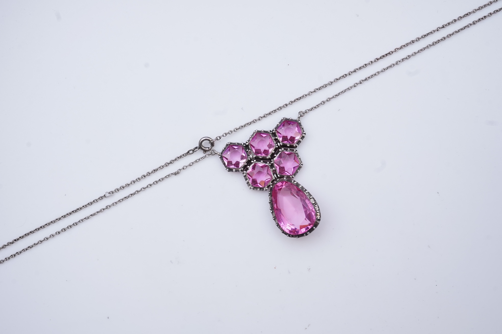 A cut steel brooch, 19th century, and a pink paste pendant